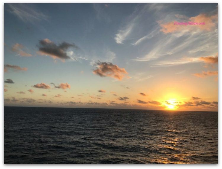 image of sunset over ocean taken from cruise balcony