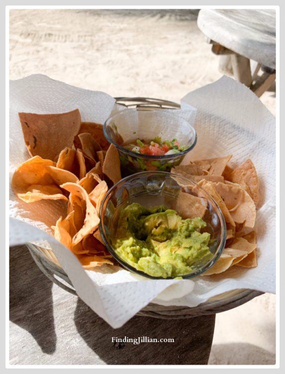 Image of chips, salsa and guacamole in a basket