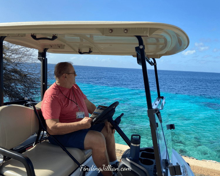 image of man touring Bonaire in golf cart during cruise in Bonaire